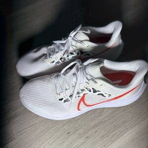 Nike White Running Sneakers with Orange Swoosh and Black Camo Accent
